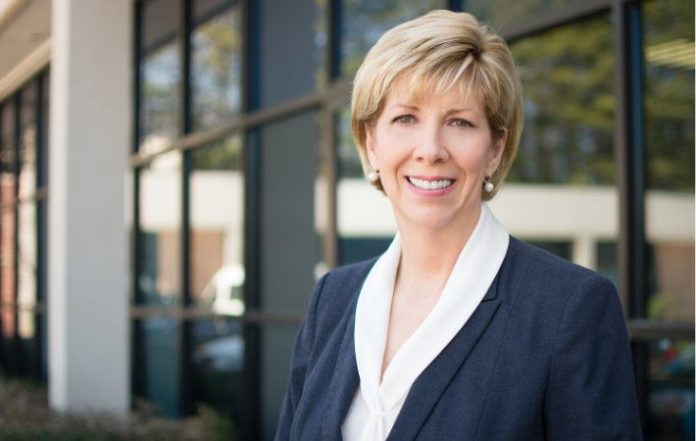 Cathy Mercer in a white shirt and black coat.